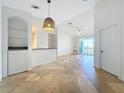 Open living room and kitchen with tile floors and neutral colors at 8803 Dunes Ct # 306, Kissimmee, FL 34747