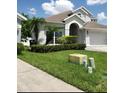 Charming two-story home with landscaped yard, lush lawn, and an attached two car garage in a suburban neighborhood at 12212 Holly Jane Ct, Orlando, FL 32824