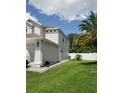 Side exterior of home with a green lawn, white fence, and palm tree at 12212 Holly Jane Ct, Orlando, FL 32824