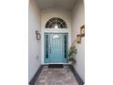 Charming entrance with a blue front door, transom window, and brick walkway at 12212 Holly Jane Ct, Orlando, FL 32824