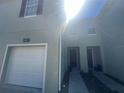 Inviting two-story townhouse featuring a single-car garage and muted color scheme at 10583 Regent Square Dr # 1206, Orlando, FL 32825