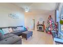 Cozy living room featuring a gray sectional sofa and fireplace at 1188 Anne Elisa Cir, St Cloud, FL 34772