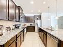 Large kitchen with dark cabinets and stainless steel appliances at 1610 Lima Ave, Kissimmee, FL 34747