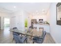 Kitchen features a glass dining table with gray velvet chairs at 1811 Coriander Dr, Kissimmee, FL 34759
