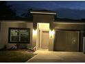 Charming home with an attached garage, freshly cut grass, and inviting entryway with exterior lighting at 19 James Ct, Davenport, FL 33837