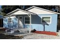 Newly renovated light blue house with white trim and landscaping at 217 W Chelsea St, Deland, FL 32720