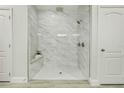 Large walk-in shower with marble tile and bench at 286 Begonia Ln, Kissimmee, FL 34759