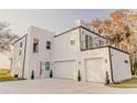 Contemporary white two-story home with two-car garage and balcony at 3000 Tohopekaliga Dr, St Cloud, FL 34772