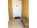 Inviting condo entry with a white door and a bench at 3719 Conroy Rd # 2023, Orlando, FL 32839