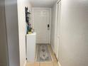 Hallway features a tile floor, white walls, and a closet, offering a neutral space at 4149 S Semoran Blvd # 10, Orlando, FL 32822