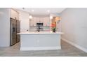 Modern kitchen with island, stainless steel appliances, and light cabinets at 4411 Sw 132Nd Pl, Ocala, FL 34473