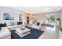 Open-concept living space with L-shaped sofa, dining area, and kitchen at 4411 Sw 132Nd Pl, Ocala, FL 34473