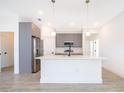 Modern kitchen with gray cabinets and a large island at 4690 Sw 139Th Place, Ocala, FL 34473