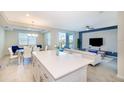 Modern kitchen with island, stainless steel appliances, and breakfast bar at 4731 Clock Tower Dr # 206, Kissimmee, FL 34746