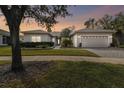 One-story house with landscaped yard and two-car garage at 554 Heartwell Dr, Kissimmee, FL 34759