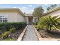 Welcoming front entry with a brick walkway and lush landscaping at 554 Heartwell Dr, Kissimmee, FL 34759