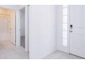 Bright hallway with tile floors and doors to bathroom and bedroom at 566 Pawnee Ct, Haines City, FL 33844