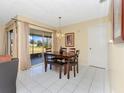 Dining area with a wooden table and chairs, near the living room at 713 Green Ct, Kissimmee, FL 34759