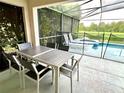 Outdoor patio furniture with a view of the pool and lake at 8417 Secret Key Cove, Kissimmee, FL 34747