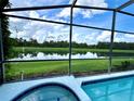 Relaxing pool and spa area with a stunning lake view at 8417 Secret Key Cove, Kissimmee, FL 34747