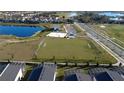 Aerial view of community featuring a recreational area, parking, and stunning water views at 853 Ocean Course Ave # 853, Davenport, FL 33896