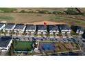 Aerial view of a residential community showcasing modern townhomes, a playground, and recreational facilities near a golf course at 853 Ocean Course Ave # 853, Davenport, FL 33896