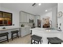 Spacious kitchen with gray cabinets, quartz countertops, and stainless steel appliances at 8614 La Isla Dr, Kissimmee, FL 34747