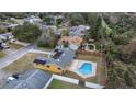 Aerial view showcasing home with solar panels and a private pool nestled in a fenced backyard at 927 Mare Bello Dr, Winter Park, FL 32792