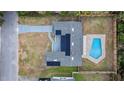 Aerial view showcasing the home's layout, solar panels, a private pool, and fenced yard at 927 Mare Bello Dr, Winter Park, FL 32792