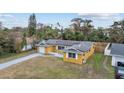 Charming one-story home featuring solar panels, an attached garage and a cozy front yard at 927 Mare Bello Dr, Winter Park, FL 32792