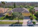 An aerial view showcasing the roof, landscaping, and surrounding neighborhood of this one story home at 127 Terra Vista Ln, Kissimmee, FL 34759