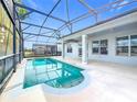 Refreshing pool area with screened enclosure and covered patio, perfect for outdoor relaxation at 1404 Lexington Avenue, Davenport, FL 33837