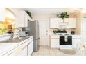 Functional kitchen with modern appliances, white cabinets, and ample counter space at 143 Hollingshead Loop, Davenport, FL 33896