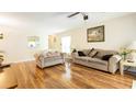 Bright living room featuring hardwood floors and neutral décor, perfect for relaxing at 143 Hollingshead Loop, Davenport, FL 33896