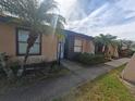 Condo building exterior with walkway and landscaping at 2024 Trinidad Ct, Kissimmee, FL 34741