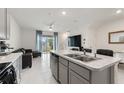 Open concept kitchen and living area with modern finishes and plenty of natural light at 2352 Tay Wes Dr, St Cloud, FL 34771