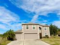 Two-story house with a two-car garage and a spacious front yard at 2403 Melissa Ann Ct, Kissimmee, FL 34746
