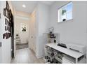 Bright home office with white desk, printer and built-in shelving at 2935 Rapollo Ln, Apopka, FL 32712