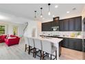 Modern kitchen with dark cabinetry, white countertops, and an island at 2935 Rapollo Ln, Apopka, FL 32712