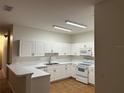Bright eat-in kitchen with white cabinets and tile floor at 3133 Sun Lake Ct # B, Kissimmee, FL 34747