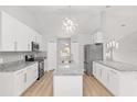 Spacious kitchen with white cabinets, granite countertops, and an island at 4181 Sw 111Th Pl, Ocala, FL 34476