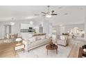 Bright and airy living room featuring an open floor plan, modern furnishings, and wood-look flooring at 4181 Sw 111Th Pl, Ocala, FL 34476