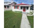 Charming home with a red roof, red door, and a well-manicured front yard at 433 Pennsylvania Ave, St Cloud, FL 34769