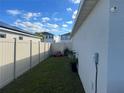 Small backyard with a wooden fence and a lawn at 503 Summer Grove Ln, Haines City, FL 33844