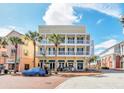 Three-story building with balconies and ground floor retail at 600 Market St # 210, Celebration, FL 34747