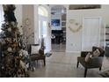 Inviting foyer with a decorated entrance, stylish seating, and views into other rooms at 6002 Renaissance Ct, St Cloud, FL 34772