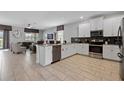 Open concept kitchen with island and stainless steel appliances at 641 Pebble Beach Dr, Davenport, FL 33896