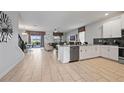 Open concept kitchen with island, stainless steel appliances, and view of living area at 641 Pebble Beach Dr, Davenport, FL 33896