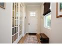 Bright entryway with French doors, hardwood floors and shoe bench at 7637 Sand Pierre Ct, Kissimmee, FL 34747