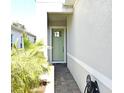Front entrance with a light green door and a brick walkway at 7637 Sand Pierre Ct, Kissimmee, FL 34747